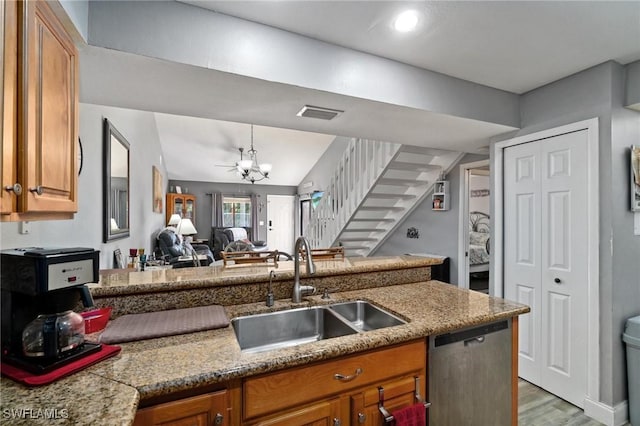 8913 Somerset Blvd, Fort Myers, FL 33919 - kitchen with a sink, a notable chandelier, wood finished floors, brown cabinets, and dishwasher