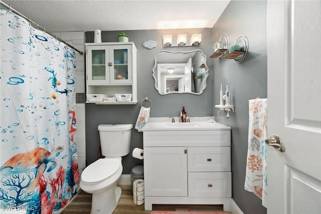8913 Somerset Blvd, Fort Myers, FL 33919 - bathroom with baseboards, wood finished floors, vanity, and toilet