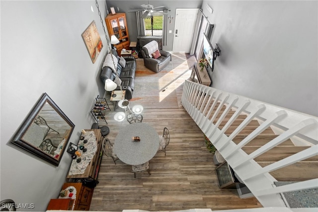 living room featuring wood-type flooring and ceiling fan