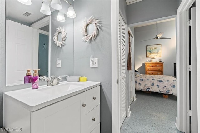 8913 Somerset Blvd, Fort Myers, FL 33919 - bathroom featuring visible vents, vanity, speckled floor, and ceiling fan