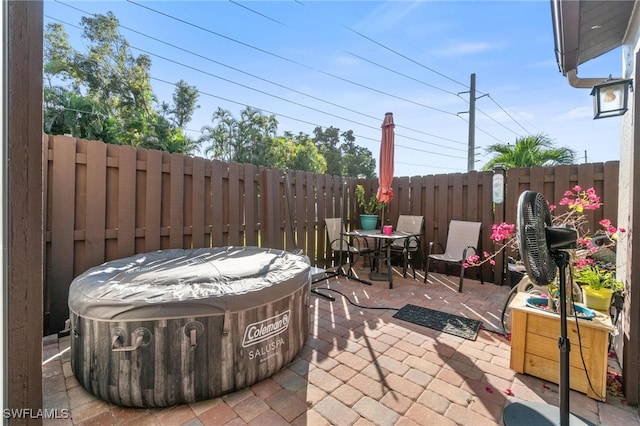 view of patio / terrace with a hot tub