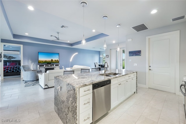 kitchen featuring hanging light fixtures, white cabinetry, an island with sink, dishwasher, and sink