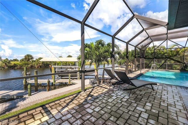 view of patio featuring glass enclosure and a water view