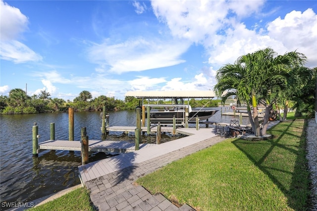 view of dock featuring a water view and a yard