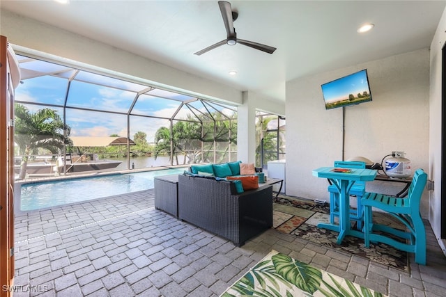 view of patio / terrace featuring glass enclosure, ceiling fan, and an outdoor hangout area