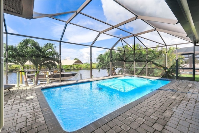 view of pool featuring a patio, a water view, and a lanai