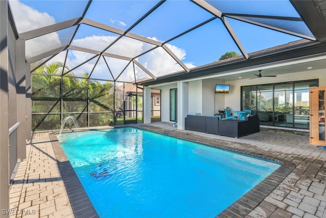 view of swimming pool featuring glass enclosure, an outdoor living space, ceiling fan, and a patio