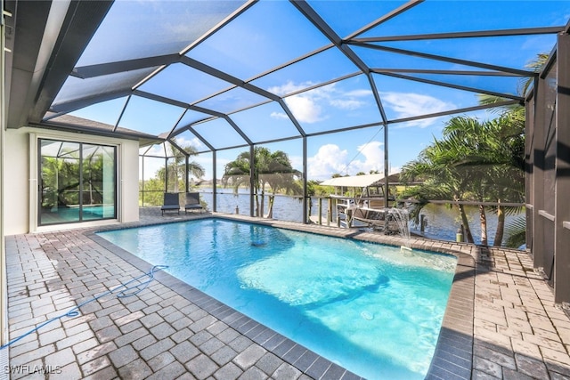 view of swimming pool featuring pool water feature, a patio, a water view, and a lanai