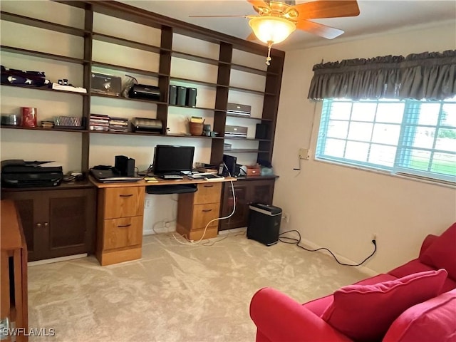 carpeted home office featuring ceiling fan