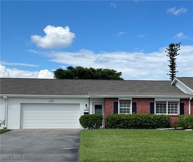 ranch-style house with a front yard and a garage