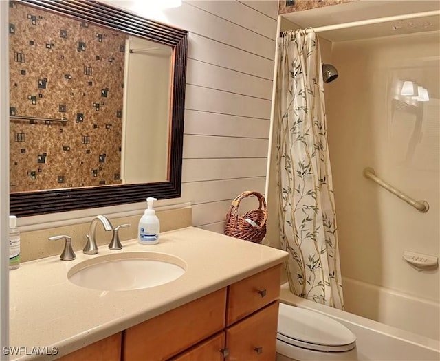 full bathroom with shower / bath combo with shower curtain, vanity, toilet, and wooden walls