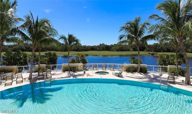 view of pool with a water view, a community hot tub, and a patio