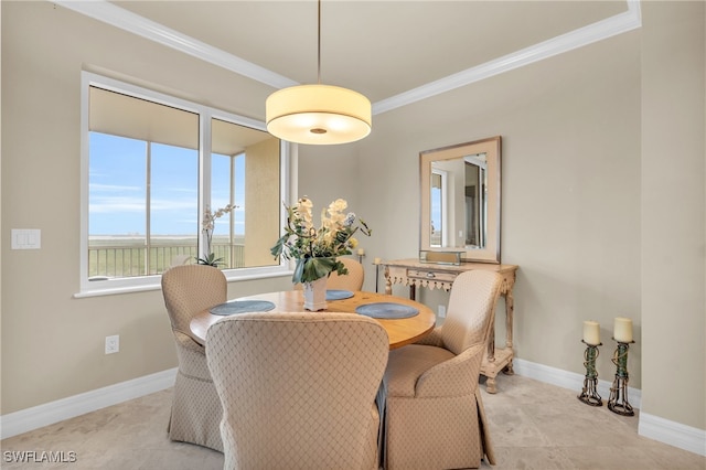 dining space with crown molding