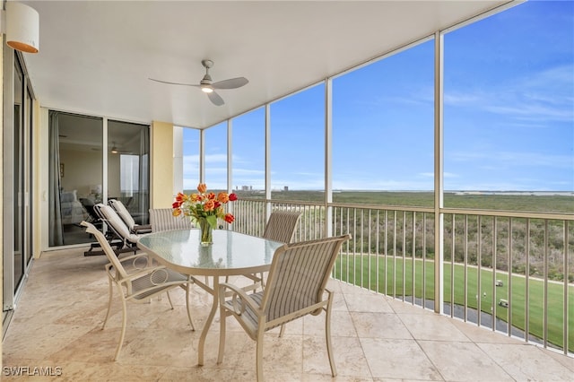 sunroom / solarium featuring ceiling fan