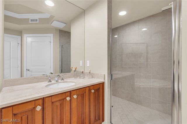 bathroom with vanity and a shower with shower door