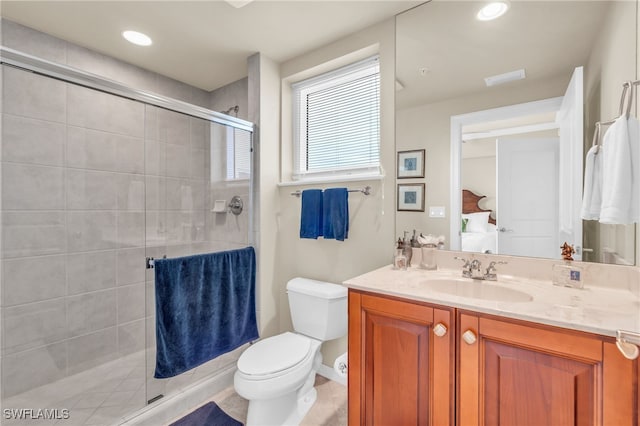 bathroom with vanity, toilet, and an enclosed shower