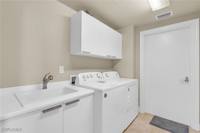 clothes washing area with cabinets, independent washer and dryer, sink, and light tile patterned floors