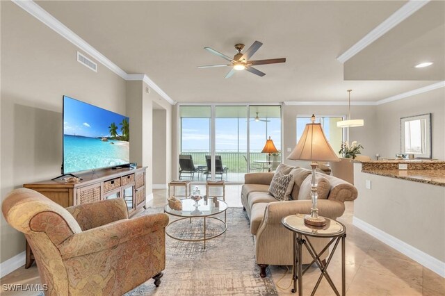 4751 W Bay Blvd Unit 1005, Estero, FL 33928 - tiled living room with a ceiling fan, baseboards, ornamental molding, and a wall of windows