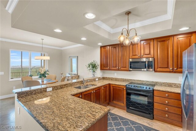 4751 W Bay Blvd Unit 1005, Estero, FL 33928 - kitchen featuring appliances with stainless steel finishes, a sink, a tray ceiling, a peninsula, and brown cabinets