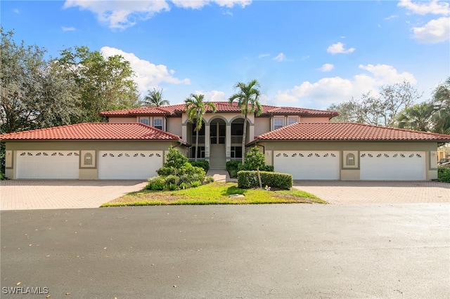 mediterranean / spanish-style home with a garage