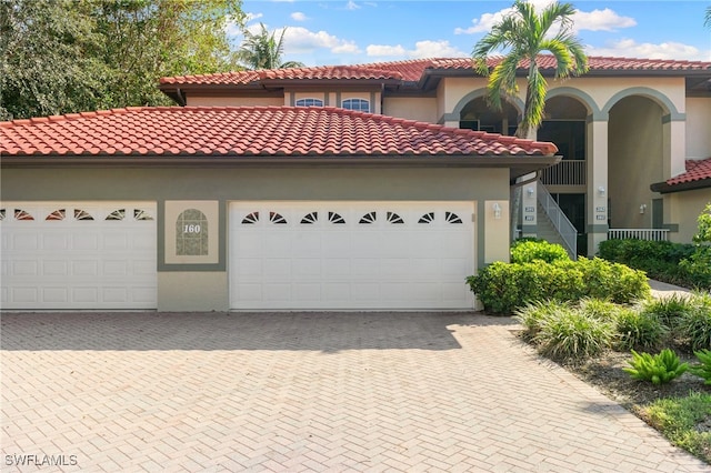 mediterranean / spanish house with a garage