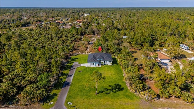 birds eye view of property featuring a view of trees