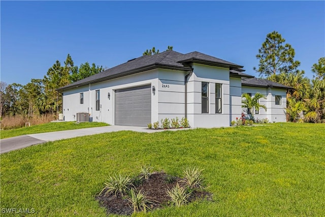 view of side of property with cooling unit, a garage, concrete driveway, a lawn, and stucco siding