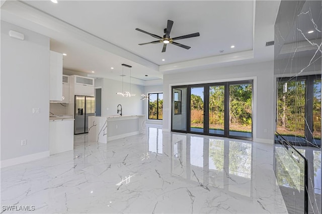 spare room with baseboards, visible vents, a raised ceiling, and recessed lighting