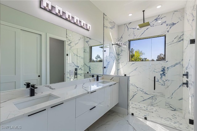 bathroom with recessed lighting, a sink, marble finish floor, a marble finish shower, and double vanity