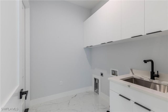 washroom featuring marble finish floor, cabinet space, hookup for an electric dryer, a sink, and baseboards