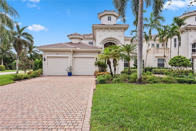 mediterranean / spanish-style house with a garage and a front lawn