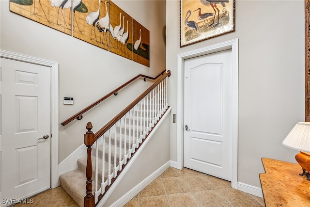 stairway featuring tile patterned flooring