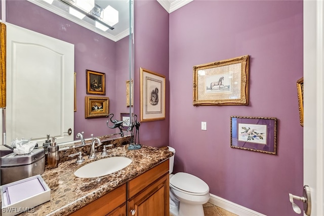 bathroom with vanity, toilet, ornamental molding, and tile patterned flooring