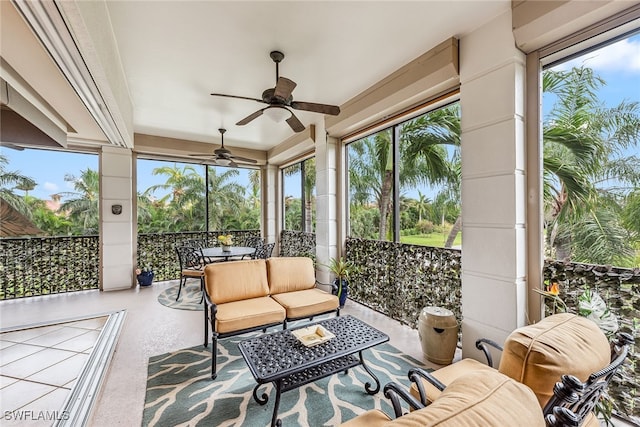 sunroom / solarium featuring ceiling fan