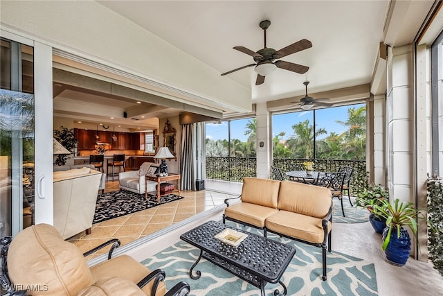 sunroom featuring ceiling fan