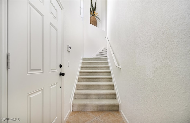 stairway featuring tile patterned floors