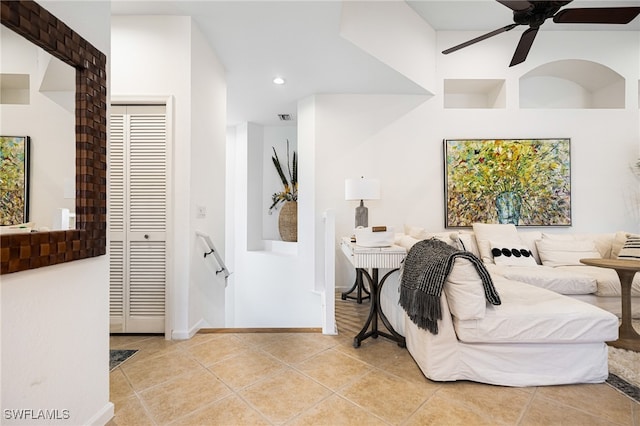 bedroom featuring a closet, light tile patterned floors, and ceiling fan