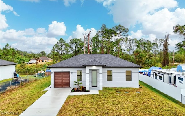 view of front of property with a front lawn and a garage