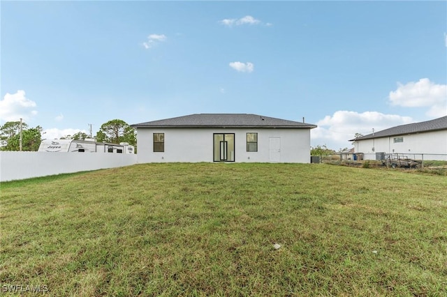 back of house with a lawn