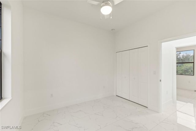 unfurnished bedroom featuring a closet and ceiling fan