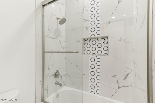 bathroom featuring toilet and tiled shower / bath