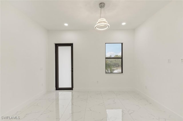 empty room featuring a notable chandelier