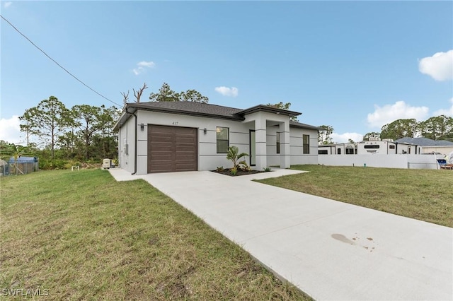 view of front facade with a front yard and a garage