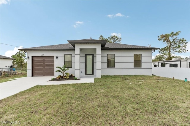 view of front of property featuring a front yard and a garage