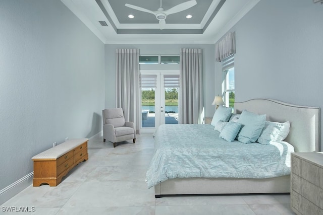 bedroom with ceiling fan, access to exterior, a tray ceiling, ornamental molding, and french doors