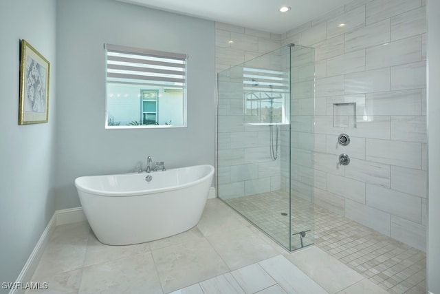 bathroom featuring independent shower and bath and tile patterned flooring