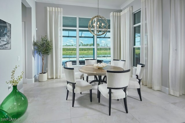 dining room with a notable chandelier, ornamental molding, and a water view