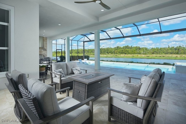 view of patio with outdoor lounge area, a water view, glass enclosure, and ceiling fan