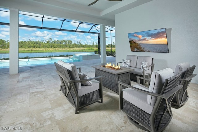 view of patio featuring a water view, an outdoor living space with a fire pit, and glass enclosure