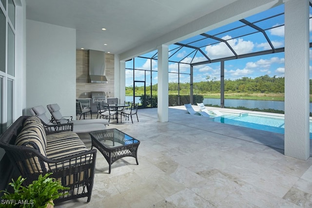 view of patio / terrace with a water view and a lanai